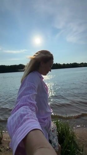Woman enjoys sunny afternoon along Volkhov River in Kirishi