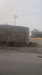 Heavy fog blankets Achocalla, Bolivia streets during midday