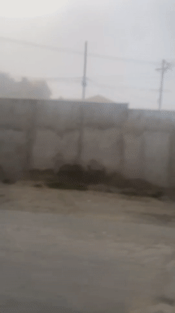Heavy fog blankets Achocalla, Bolivia streets during midday