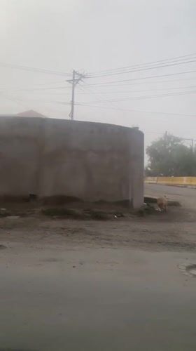 Heavy fog blankets Achocalla, Bolivia streets during midday