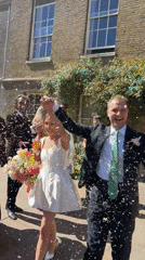 Newlyweds celebrate with confetti toss outside London wedding venue