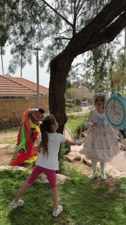 Children celebrate with piñata game at Netanya park birthday party