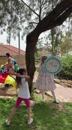Children celebrate with piñata game at Netanya park birthday party