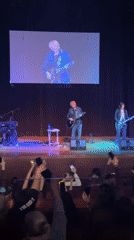 Three-piece band performs live in Sliven, Bulgaria auditorium