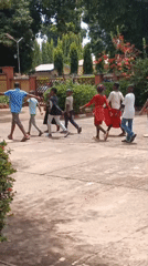 Children walk in synchronized formation in Nigerian community