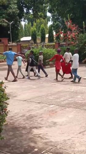 Children walk in synchronized formation in Nigerian community