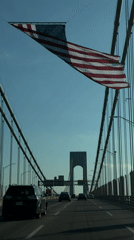 Fourth of July drive across a flag-lined New York bridge