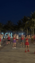 Evening aerobic group exercise session near Da Nang Beach