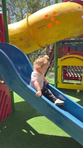 Child plays on playground slide in Haifa