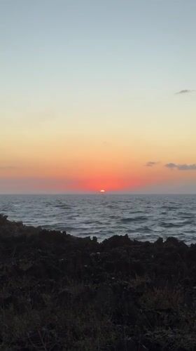 Tourists capture sunset and crashing waves at Kuta Selatan coastline