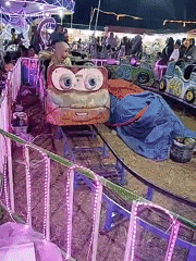 Community carnival night in Tasikmadu with rides, games, and coloring stalls