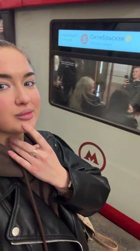 Woman documents evening Metro commute at Moscow's Oktyabrskaya station
