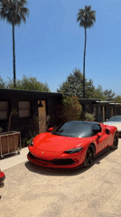 Luxury sports cars lined up outside a Malibu building
