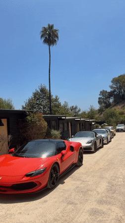 Luxury sports cars lined up outside a Malibu building