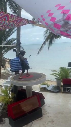Man performs nunchuck routine on platform in Ban Haad Rin