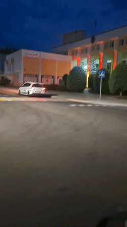 Dusk street scene near a red-lit building in Shklov, Belarus