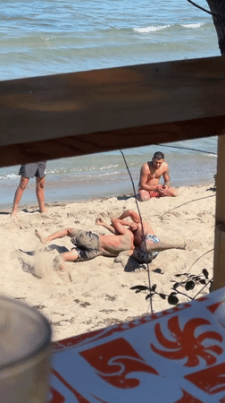 Young men enjoy beach day activities in Tsarevo, Bulgaria