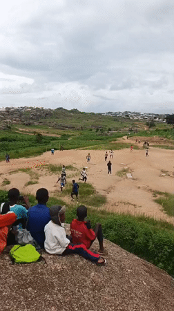 Pickup soccer on a rocky dirt field in Jos, Nigeria