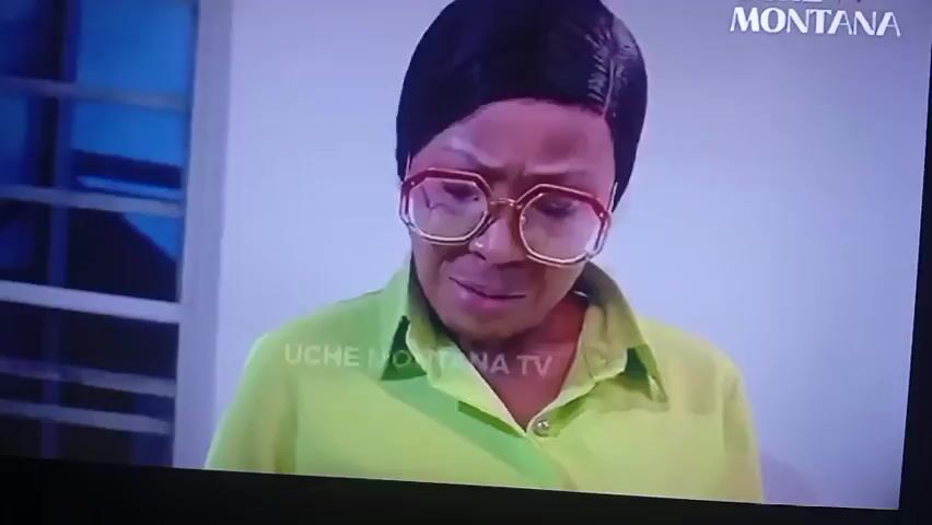 A woman with dark hair pulled back and wearing large, clear-rimmed glasses is looking down intently, her lips slightly parted. She is wearing a bright green shirt. The text "UCHE MONTANA TV" is overlaid on her chest. The text "Very precise." appears at the bottom of the screen. The scene then cuts to a woman with dark hair, wearing a light-colored patterned top and gold earrings, smiling slightly as she looks down at a sewing machine. To her right, a portion of a red, sequined fabric is visible. The text "The design." appears at the bottom of the screen.