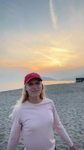 Woman in athletic wear observed on Alanya beach at sunset