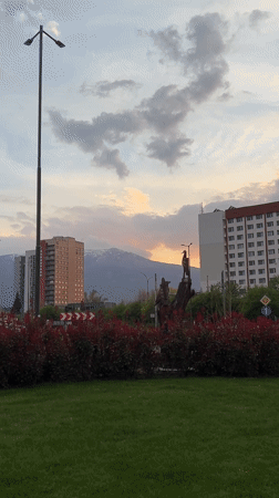 Sofia residents document sunset cityscape with Vitosha Mountain backdrop