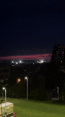 Belgrade sunset illuminates construction cranes during evening twilight