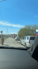 Vehicle parade observed on Krasnoyarsk street during sunny morning