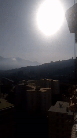 Sunny day captured over Caracas skyline with mountain backdrop