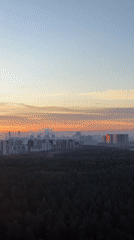 Moscow sunrise transforms skyline in orange and pink hues