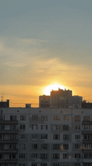 Woman documents evening meal prep and snacks during urban sunset