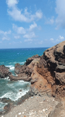 Waves crash against rocky coastline in Phú Quý, Vietnam