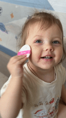 Woman's morning skincare routine with toddler in Reshetnikovo