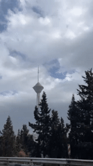 Milad Tower documented under cloudy skies in Tehran