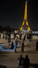 Evening street performances enliven Paris near Eiffel Tower, subway