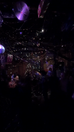 Nightlife scene captured at Paris bar with dancing, bubbles