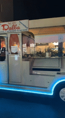 Tourist train and quadricycle share Gatteo's summer night streets