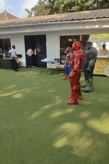 Marvel costumed gathering observed in outdoor grassy area