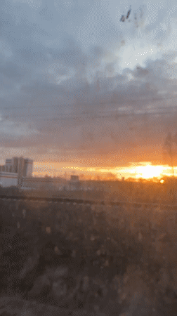 Orange sunrise viewed through dirty window in Zhilevo, Russia