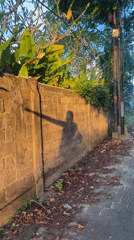 Tourist documents leisurely walk through Kuta streets during golden hour