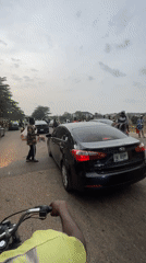 Motorcycle rider films black Kia on busy Abuja street