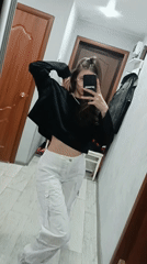 Woman takes extended selfie session in hallway mirror