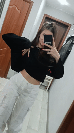 Woman takes extended selfie session in hallway mirror