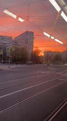 Sunset illuminates Saint Petersburg street scene from public transit