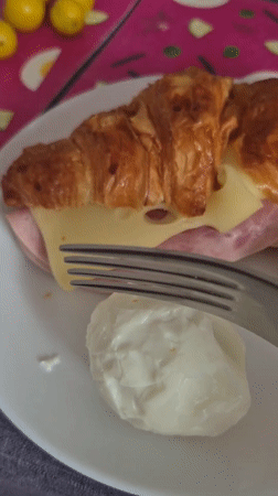 Croissant sandwich and boiled eggs at a Latvian breakfast table
