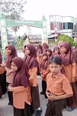 Students in uniform gather outdoors at a Keudekrueng school