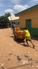 Carts and commerce moving through a Nigerian village road