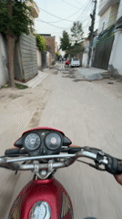 Motorcyclist travels through Pakistani residential neighborhoods