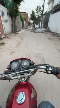 Motorcyclist travels through Pakistani residential neighborhoods