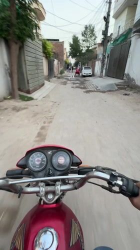 Motorcyclist travels through Pakistani residential neighborhoods