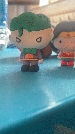 DC action figures arranged on a blue surface in Tuscany